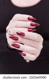 Female Hands With Long Nails And Dark Red Nail Polish