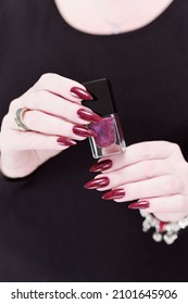 Female Hands With Long Nails And Dark Red Nail Polish