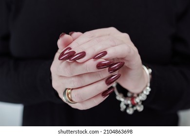 Female Hands With Long Nails And Dark Red Nail Polish