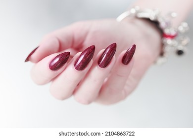 Female Hands With Long Nails And Dark Red Nail Polish