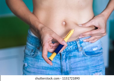 Female hands make injections of hormones in the stomach In Vitro Fertilization Injection Pen. Fertility / infertility and menopause