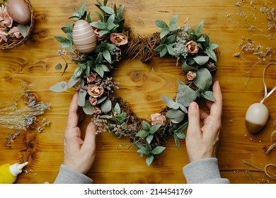 Female Hands Makes Easter Flower Wreath. Spring Home Decoration. DIY Home Decor Crafts.