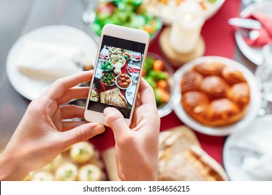 Female Hands Making Photo Of Healthy Vegetarian Family Holiday Dinner Setting On Smartphone. Christmas, New Year, Thanksgiving, Anniversary, Hanukkah, Mothers Day, Food Photo And Delivery Concept