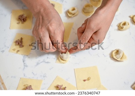 Female hands making Turkish dumpling   
