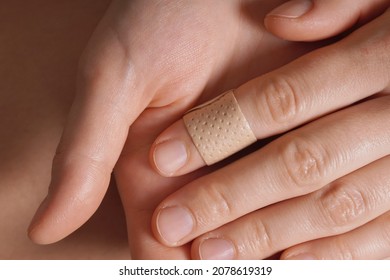 Female Hands With A Medical Plaster On Finger.