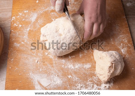 Female hands mixing dough in the home kitchen.