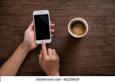 Female hands with mobile phone and cup of coffee on wooden background - Powered by Shutterstock