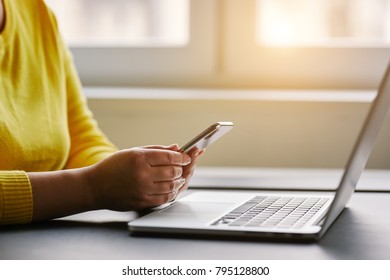 Female Hands With Mobile Phone And Laptop In Office