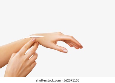 Female Hands With A Moisturiser On Light Background. Close-up Of Woman Applying Cream On Hand. Hands Skin Care. 