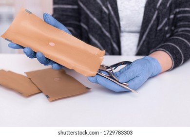 Female Hands Of Nail Master Taking From Craft Package Manicure Instruments After Sterilisation 