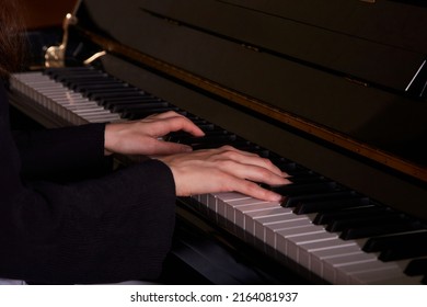 Female Hands On Black Piano Keys