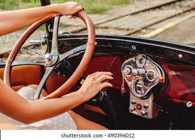 Female Hands On Classic Car Steering Wheel And Shift