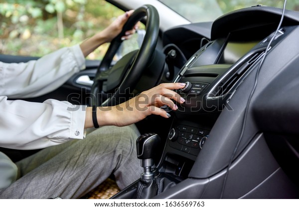 Female hands on steering wheel of a car. Woman\
driver, car interior