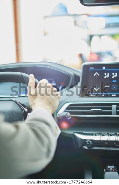 female hands on the\
steering wheel of a car