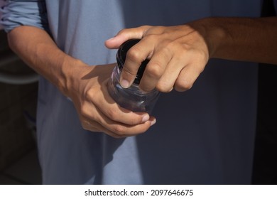 Female Hands Opening A Glass Jar.