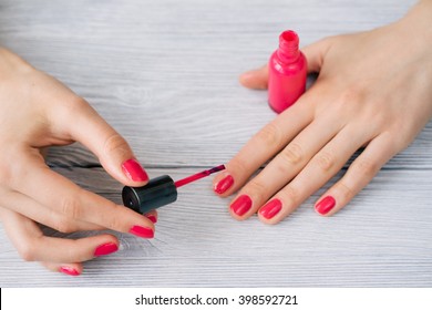 Female hands painted nails with red lacquer
