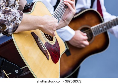 Female Hands Playing Acoustic Guitar At Street Concert