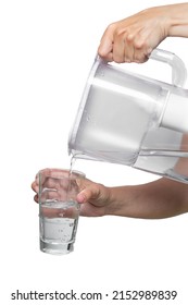 Female Hands Pour Clean Water From A Filter Jug Into A Glass Beaker On A White Background