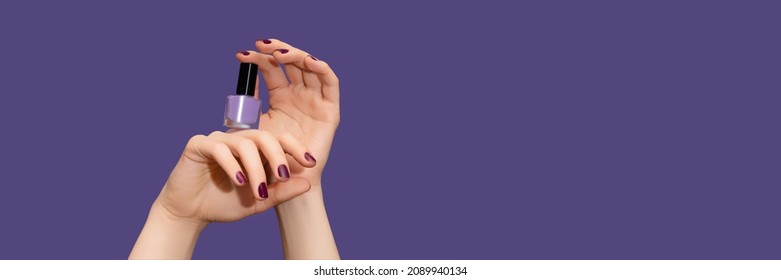 Female hands with purple nail design. Glitter purple nail polish manicure. Female hands hold purple nail polish on purple background. Copy space. Banner ad template. Advertising banner. - Shutterstock ID 2089940134
