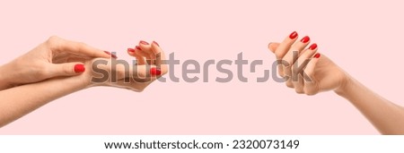 Female hands with red manicure on light pink background. Banner for design