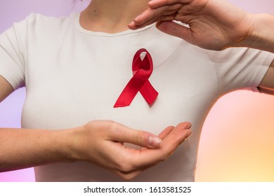 Female hands with red ribbon. Social advertising. Healthcare concept - Shutterstock ID 1613581525