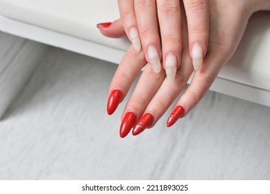 Female Hands With Regrown Red Gel Nails Close-up