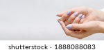 Female hands with rose nail design. Pink glitter nail polish manicure on white background. Nail design copy space