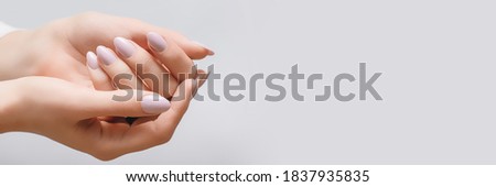 Female hands with rose nail design. Pink glitter nail polish manicure. Woman hands on white background. Banner