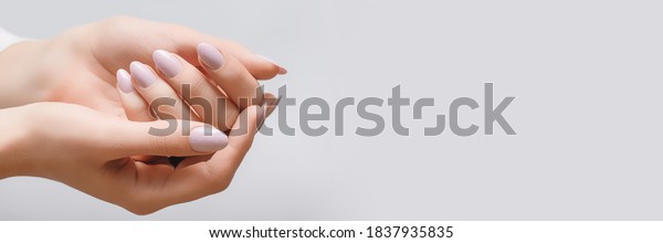 Female hands with\
rose nail design. Pink glitter nail polish manicure. Woman hands on\
white background. Banner