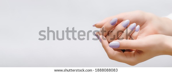 Female hands\
with rose nail design. Pink glitter nail polish manicure on white\
background. Nail design copy\
space