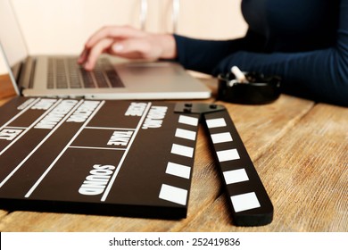 Female Hands Of Scriptwriter Working On Laptop At Desk On Cupboard Background