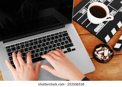 Female Hands Of Scriptwriter Working On Laptop At Wooden Desk Background