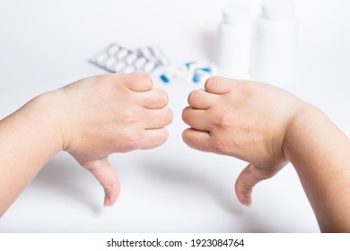 Female hands showing thumb down for medicines, on white background. - Shutterstock ID 1923084764