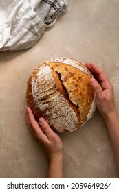 Female Hands With Sourdough Bread On Rustic Background. Top View, Copy Space For Text