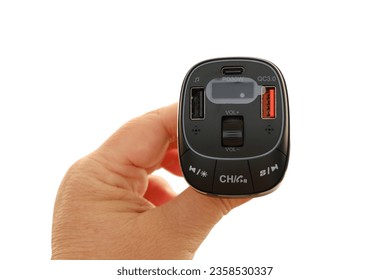 female hands with special device  transmitter or receiver, electronic device for music in car from phone, concept of listening to favorite music