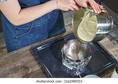 Female Hands Spread The Dough In A Round Baking Dish