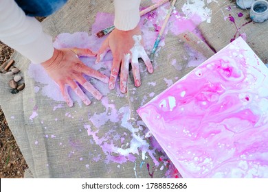 Female Hands Stained With Acrylic Paint Draws On A Canvas Outdoors. Art Therapy Painting Concept