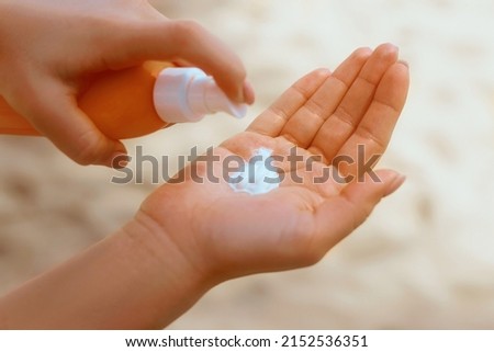 Female hands with sun protection cream Skin care concept.  Sunscreen Solar. The Girl Uses  Moisturizer Sunblock.