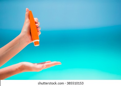 Female Hands With Suncream Bottle Background Blue Sea