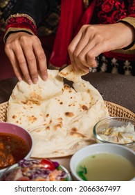 Female Hands Tearing Roti Sheets. Eating Roti With Food By Hands. Indian Traditional Chapati, Naan, Roti.