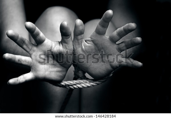 Female hands tied up with rope of a missing\
kidnapped, abused, hostage, victim, woman ,restricted,\
trapped,horror, help, struggle, terrified, threaten, locked,\
freedom, liberty concept.Copy\
space