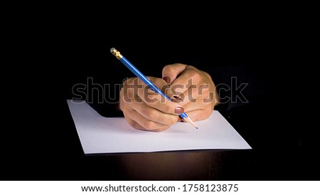 Female hands trying to write a statement. Sexual abuse and rape concept, anti-trafficking and stopping violence against women
