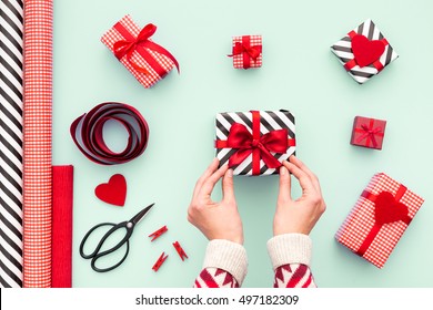 Female Hands Tying A Red Bow. Birthday, Valentines Day, Christmas, New Year. Flat Lay