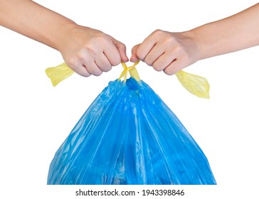 Female Hands Tying Yellow Strings Of Blue Garbage Bag