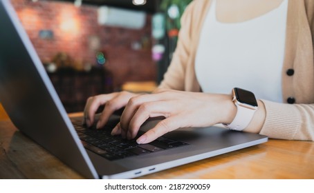 Female Hands Typing On Laptop While Sitting At Office Desk Indoors. Chatting In Facebook, Searching Information, Browsing. Technology Concept