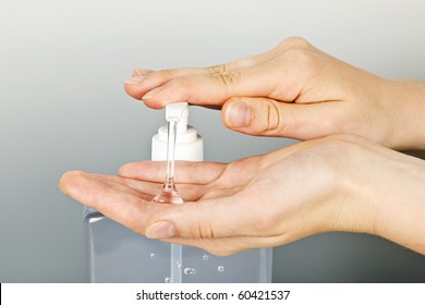 Female Hands Using Hand Sanitizer Gel Pump Dispenser