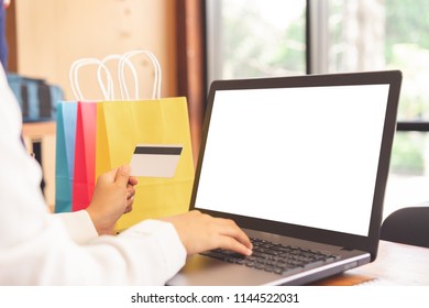 Female Hands Using Laptop Online Shopping And Pay By Credit Card.White Screen Laptop Mockup For Graphic Montage.