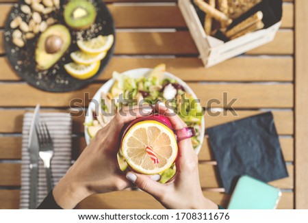 Female hands view drinking fresh smoothie fruit and eating health vegetable salad with chicken breast avocado and kiwi - Healthy nutrition food lifestyle people concept 