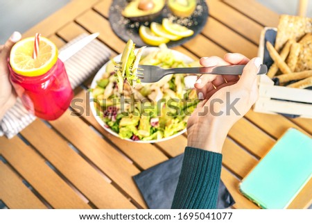 Female hands view eating health vegetable salad with chicken breast avocado kiwi and drinking fresh smoothie fruits - Healthy nutrition food lifestyle concept 