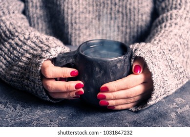 Female Hands Warm Up Hands On A Hot Cup